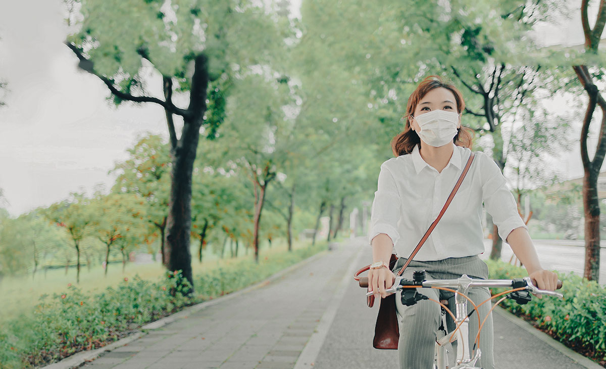 For the past one and a half year, we seemed to have been living in a cycle of lockdowns and easing of restrictions. The picture shows a woman donning a surgical mask, and cycling on a path connector.