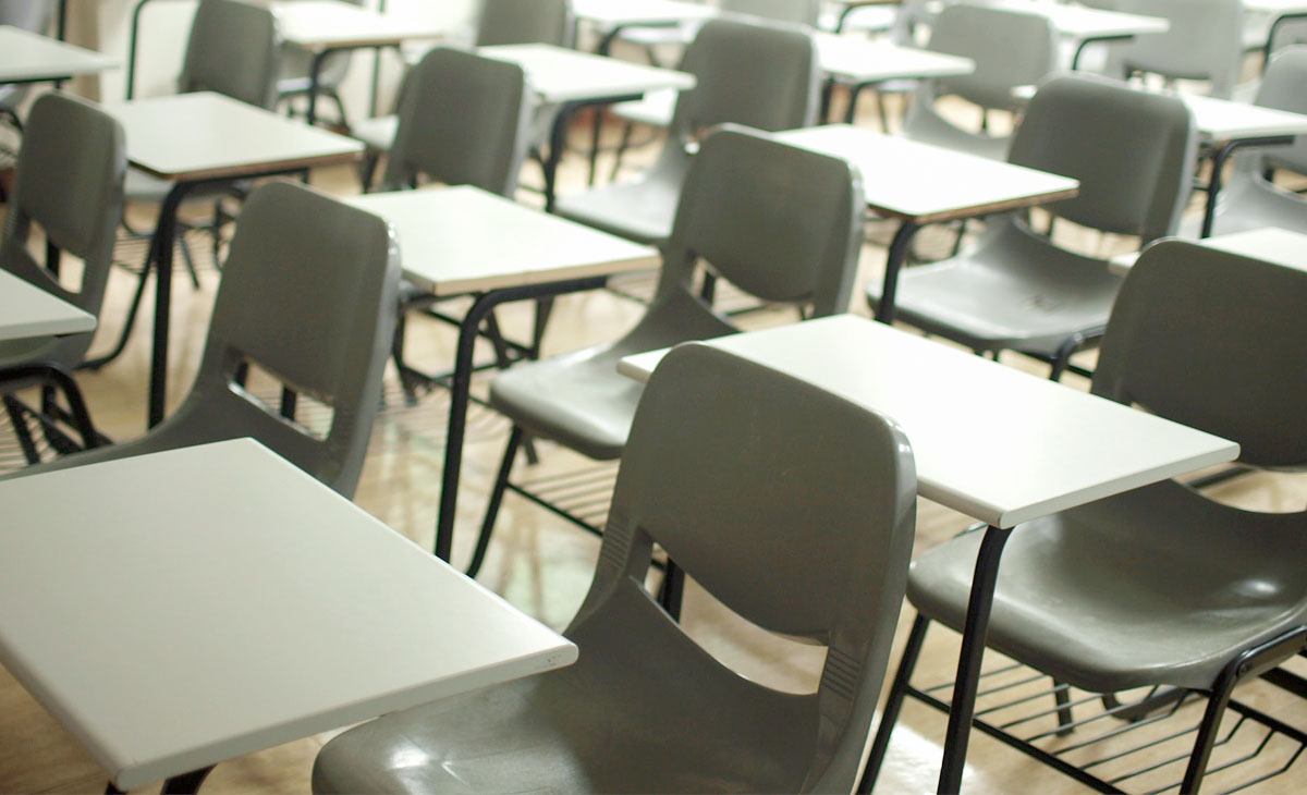 Rows of tables and chairs in a classroom